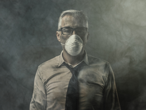 man with mask because of indoor air pollution