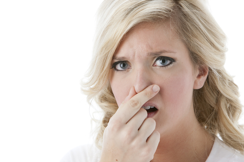 Adult Woman Holding Nose because of bad AC smell