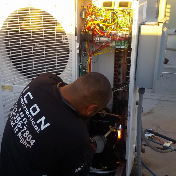 Icon Mechanical tech working on AC unit fixing HVAC airflow problems